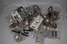 A selection of ladies fashion watches in various colours and designs, new in packaging.