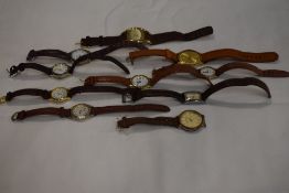 10 wrist watches all having brown straps.