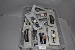 A box of ladies fashion watches in various colours and designs, new in packaging.