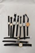 Ten girls/ ladies watches, having black straps.