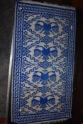 A blue and grey Turkish style prayer rug.