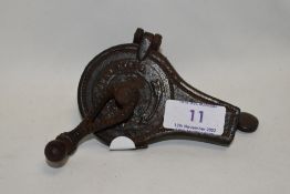 A Victorian cooks spice or similar grinder dated 1870 with cast metal case