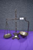 A set of Victorian apothecary or similar balance scales, cast iron frame with brass pans