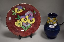 An Arts and Crafts era Royal Doulton vase having blue ground with chequer yellow panel and swirl
