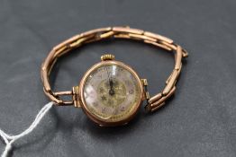 A vintage 9ct rose gold wrist watch having Arabic numeral dial in gold case on a rose gold stretch