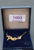An 18ct gold necklace bearing front panel in Middle Eastern italics, approx 16' & 3.6g
