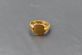 A 9ct gold signet ring, the plain shield form platform between moulded shoulders, the shank