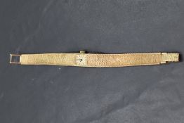 A lady's 9ct gold cocktail watch by Rotary having baton numeral dial to rectangular face on 9ct gold