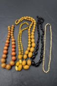 Five strings of beads including amber style, simulated pearl with gold clasp and jet style