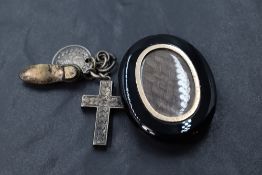 A Victorian jet mourning pendant having seed pearl decoration to front and hair locket en verso