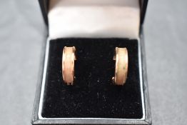 A pair of 9ct rose gold hoop earrings having brushed detail, approx 1.3g