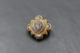 A small micro mosaic brooch of Egyptian form in a yellow metal mount testing as 18ct gold with a