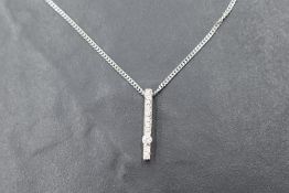 An Italian 18ct white gold diamond pendant with chain having a tension set diamond amongst 10
