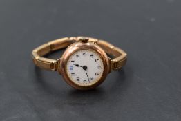 A lady's vintage 9ct rose gold wrist watch having Arabic numeral dial with gilt minute dots to white