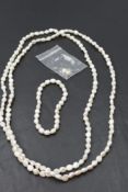 A long string of baroque pearls with matching bracelet and drop earrings