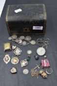 A small vintage jewellery box containing a small selection of HM silver and white metal including