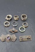 A small selection of HM silver and white metal rings and brooches of various forms
