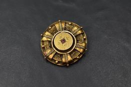 A Victorian 15ct gold brooch having ruby chip and wire decoration, approx 6.3g (AF)