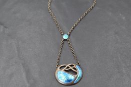An Edwardian silver and enamel Art Nouveau pendant by Charles Horner, having iridescent blue and