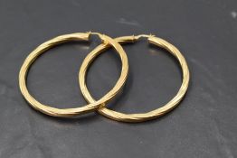 A pair of 9ct gold oversized twist hoop earrings, approx 10g