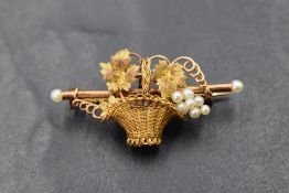 A yellow metal brooch bearing marks, probably French modelled as a basket having seed pearl