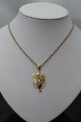 An Edwardian yellow metal pendant stamped 9ct in the Art Nouveau style having blue topaz