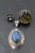 An American lapis lazuli oval pendant in a silver decorative mount bearing makers mark for Leonard