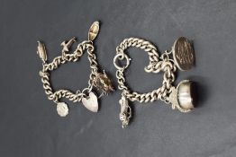 Two HM silver and white metal charm bracelets, one having three oversized charms, including watch