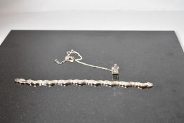 A silver articulated four bar wave style bracelet, approx 7.5' & 15.1g and a facetted crystal