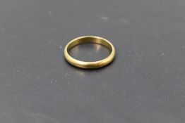 A yellow metal wedding band stamped 18K bearing inscription Proctor's Lucky to the inside, size