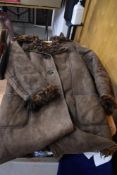 A vintage brown Antartex lamb skin jacket, having curly lining.