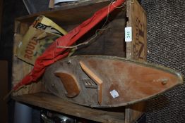 A vintage wine crate with a model sailing boat and a Roulette game
