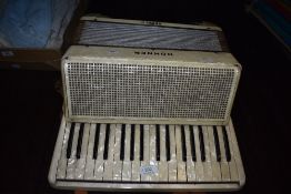 A vintage Hohner Verdi II accordian in a cream colour
