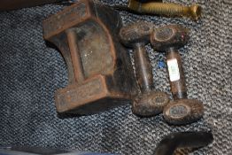 A pair of late Victorian dumbbells with a 28lb cast iron weight and a brass dagger.