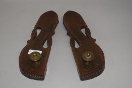 A pair of early 20th century Indian wooden craved knob toe slippers with inlayed brass decoration