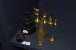 Four sets of kitchen balance scale weight sets, including brass and cast iron designs.