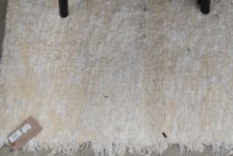 A cream and white rug, approx. 187 x 146cm