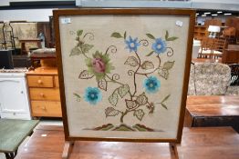An early 20th Century embroidered fire screen