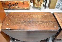 A period style heavy oak gateleg dining table
