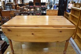 A modern pine drop leaf coffee table