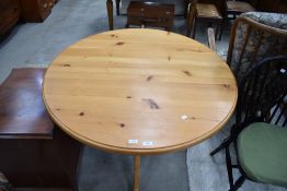 A modern pine pedestal dining table