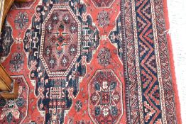 A modern carpet square of red ground with black and cream tones, approx. 236 x 171cm