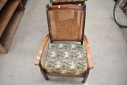 An early 20th Century stained frame bergere back armchair