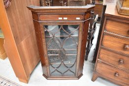 A Victorian corner cupboard with Astral glazed door and inlaid veneer details