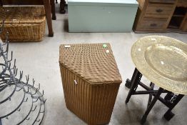 A Lloyd Loom corner linen basket