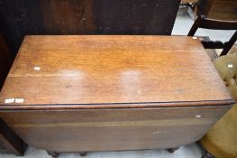 A traditional oak twist gate leg dining table