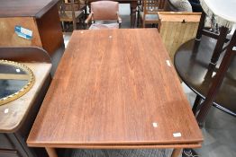 A vintage teak drawer leaf dining table