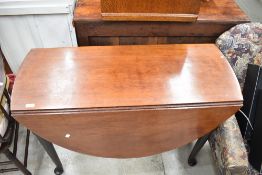 A 19th Century mahogany table having Queen Anne style gate legs
