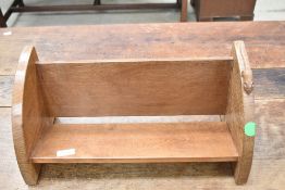 An Arts and Crafts 'Mouseman' golden oak book trough having typical mouse carved to edge