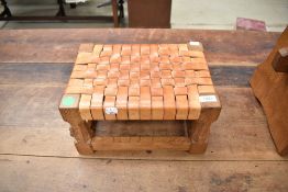 An Arts and Crafts 'Mouseman' golden oak stool with leather strapping to seat and typical mouse
